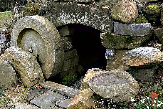 Bibelgarten in Tragwein (OÖ). Zu sehen ist eine Grabeshöhle, der Stein vor dem Grab ist zur seite gerollt.