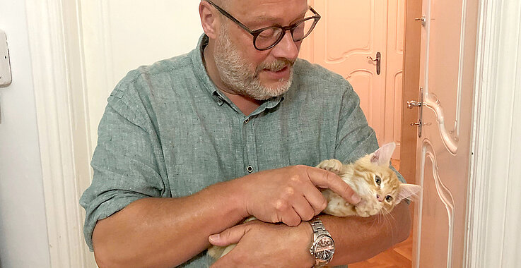 Pfarrer Bernhard Messer mit Katze am Arm